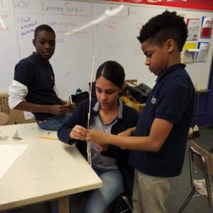 Three students working on a project together.